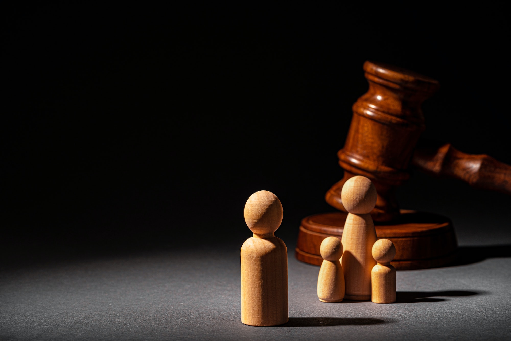 Wooden toy family and judge mallet. Family divorce concept